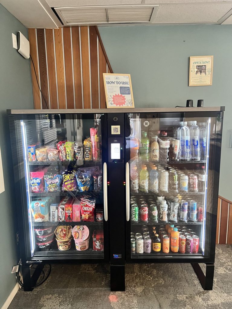 Double-door smart cooler with snacks on one side and drinks on the other, installed by Chewings Amenities